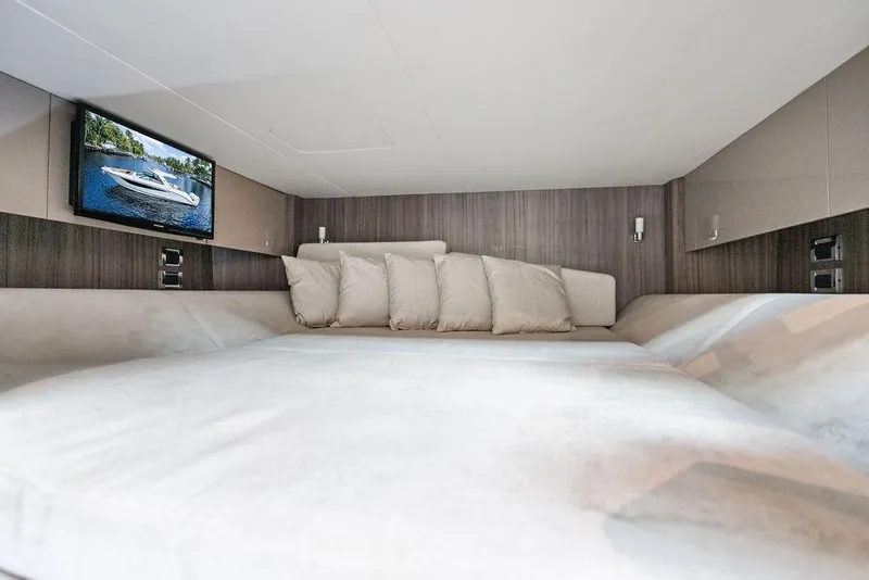 Slide: The Image of Luxurious cabin interior of 2019 Sea Ray SLX 400 OB with cozy bedding and TV. - 49