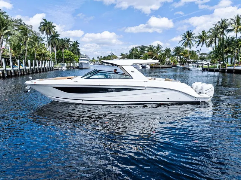 Slide: The Image of 2019 Sea Ray SLX 400 OB boat cruising on a scenic waterway with palm trees. - 8