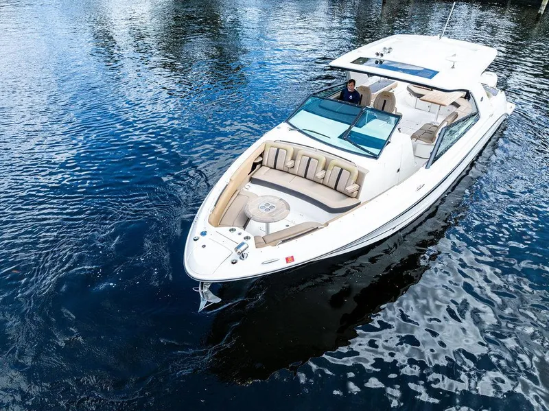 Slide: The Image of 2019 Sea Ray SLX 400 OB cruising on calm waters, showcasing luxury and style. - 9