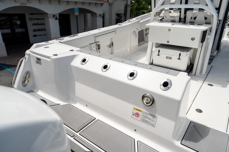Slide: The Image of 2023 Blackfin 302CC boat deck with fishing rod holders and storage. - 11