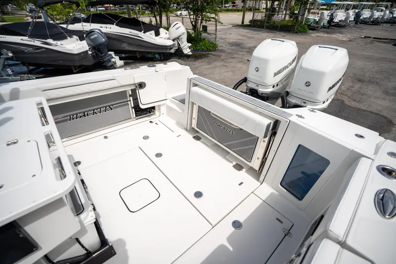 Slide: The Image of 2023 Blackfin 302CC boat deck with dual Mercury outboard engines. - 13