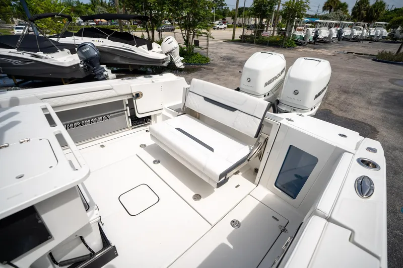 Slide: The Image of 2023 Blackfin 302CC boat with dual Mercury engines and spacious seating area. - 15