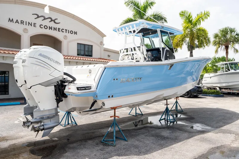 Slide: The Image of 2023 Blackfin 302CC boat displayed at Marine Connection dealership. - 2
