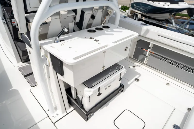 Slide: The Image of 2023 Blackfin 302CC boat interior with fishing station and cooler. - 22