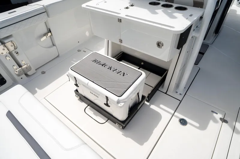 Slide: The Image of 2023 Blackfin 302CC boat interior with built-in cooler storage. - 23