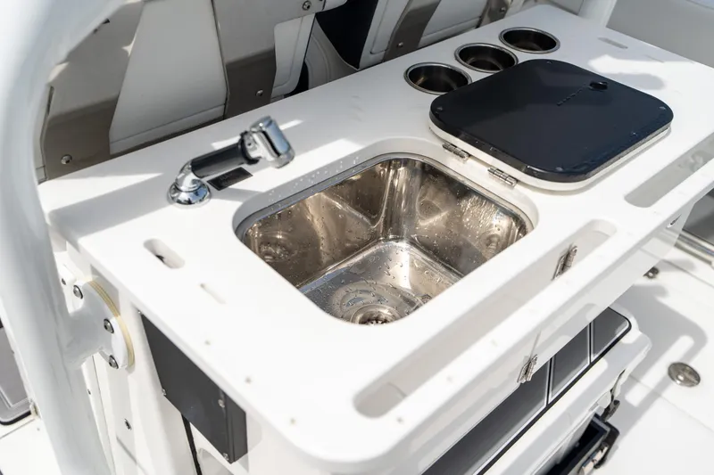 Slide: The Image of 2023 Blackfin 302CC boat sink and countertop with cup holders. - 24