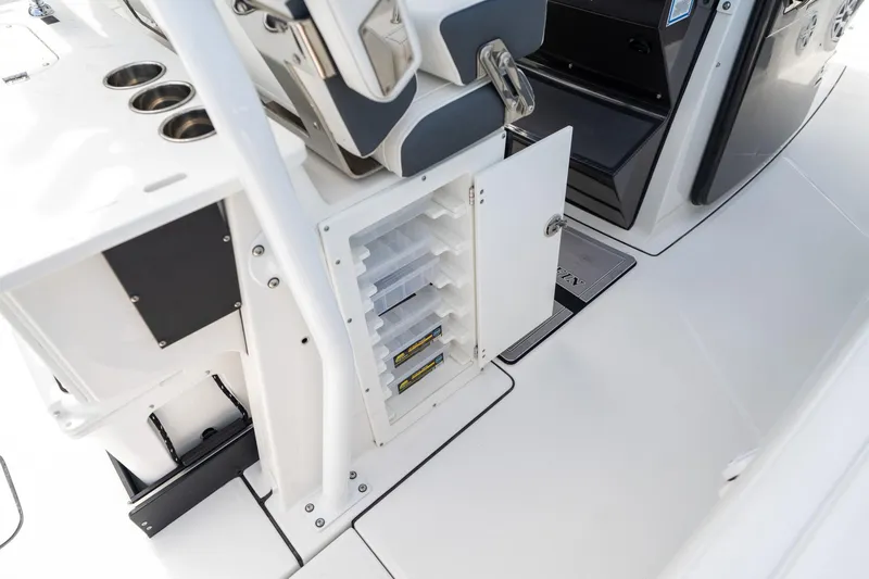 Slide: The Image of 2023 Blackfin 302CC boat interior with open storage compartment and seating. - 26