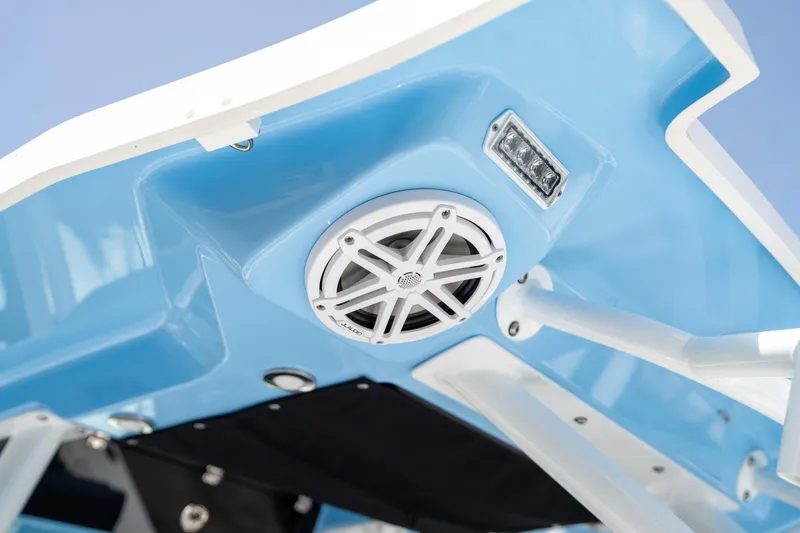 Slide: The Image of Close-up of 2023 Blackfin 302CC boat's blue underside with speaker and light. - 30