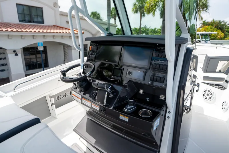 Slide: The Image of 2023 Blackfin 302CC boat cockpit with advanced navigation controls and displays. - 34