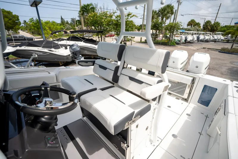 Slide: The Image of 2023 Blackfin 302CC boat interior with white seating and steering wheel. - 38