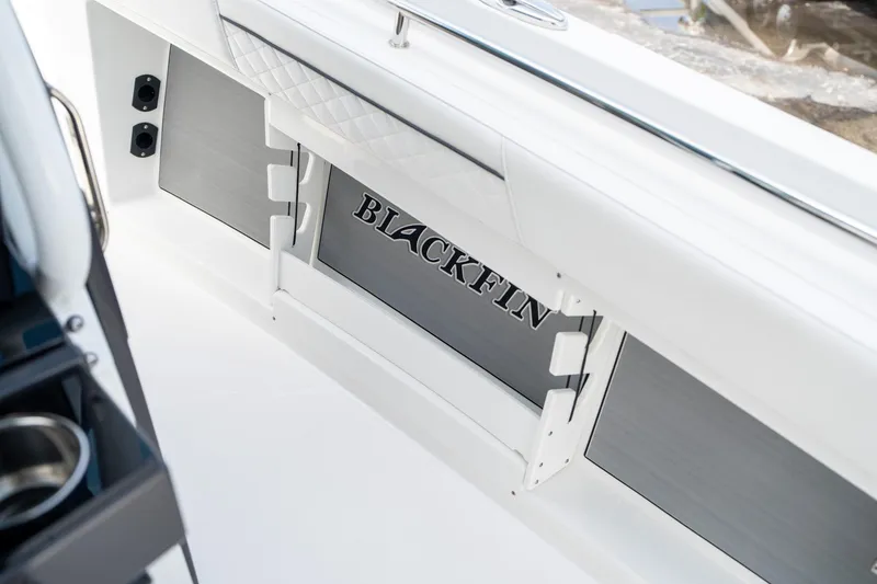 Slide: The Image of 2023 Blackfin 302CC boat interior detail with logo and sleek design elements. - 40