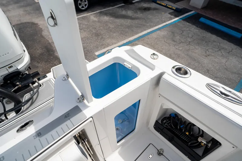 Slide: The Image of 2023 Blackfin 302CC boat deck with storage compartments and fishing equipment. - 16