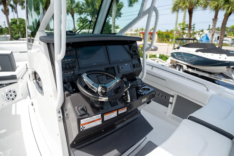 Slide: The Image of 2023 Blackfin 302CC boat cockpit with modern steering and control panel. - 33