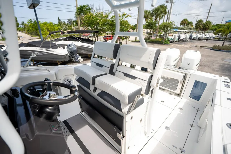 Slide: The Image of 2023 Blackfin 302CC boat interior with dual seating and steering wheel. - 36