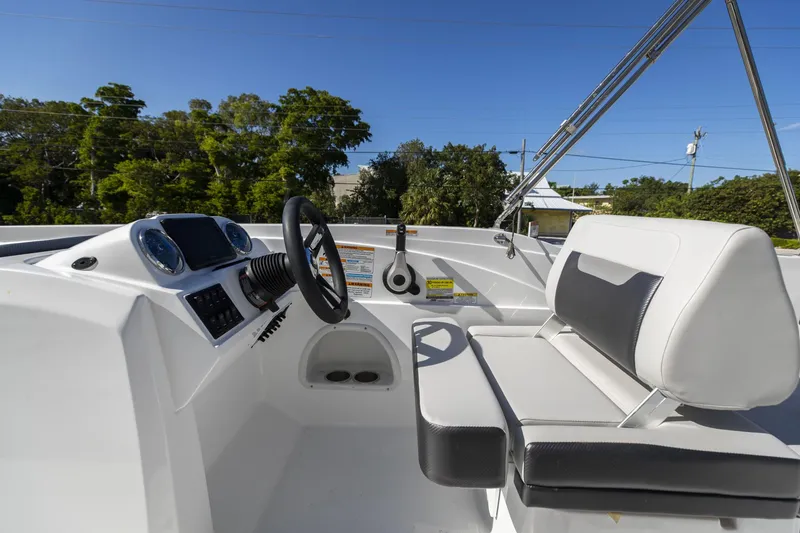 Slide: The Image of 2023 Hurricane SunDeck Sport OB SS 205 OB boat interior with steering wheel and seating. - 12