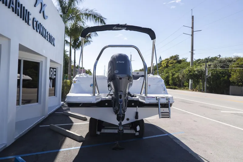 Slide: The Image of 2023 Hurricane SunDeck Sport OB SS 205 OB boat displayed outside dealership. - 4