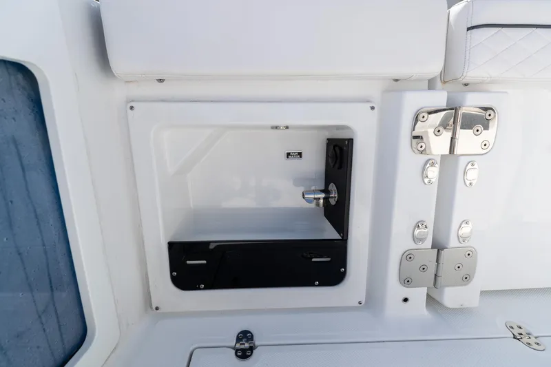 Slide: The Image of 2023 Blackfin 302CC boat compartment with stainless steel fixtures and raw water access. - 24