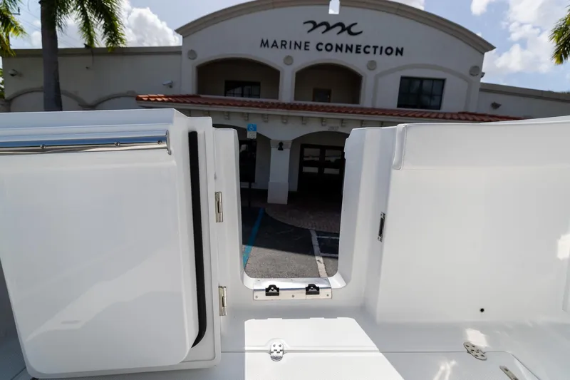 Slide: The Image of 2023 Blackfin 302CC boat at Marine Connection dealership entrance. - 26