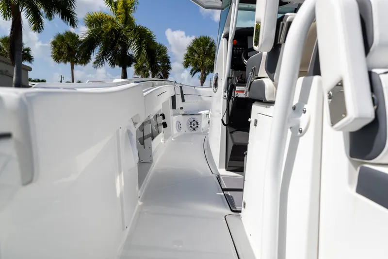 Slide: The Image of 2023 Blackfin 302CC boat interior with sleek design and palm trees in the background. - 27