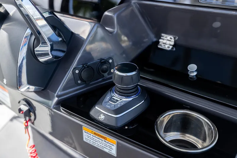 Slide: The Image of Control panel of 2023 Blackfin 302CC boat with joystick and cup holder. - 30