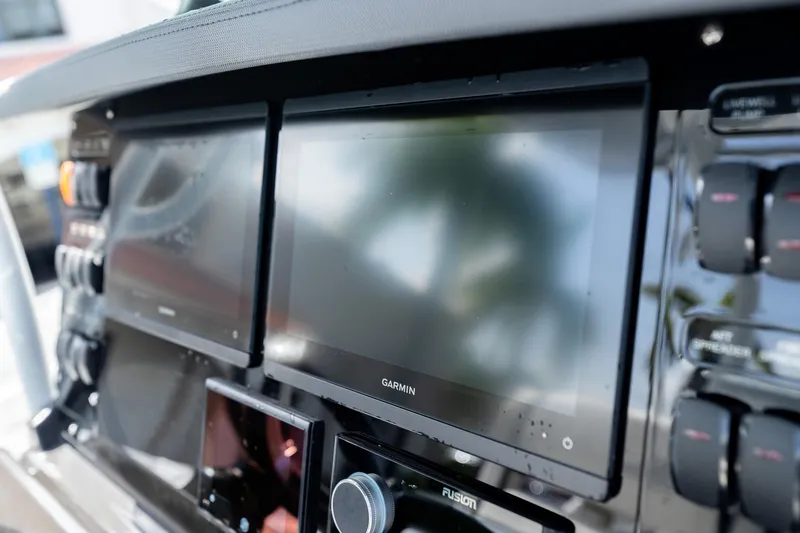 Slide: The Image of Control panel of 2023 Blackfin 302CC boat featuring Garmin displays. - 33