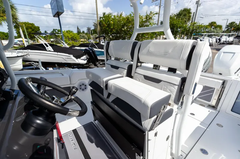 Slide: The Image of 2023 Blackfin 302CC boat interior with steering wheel and seating. - 38