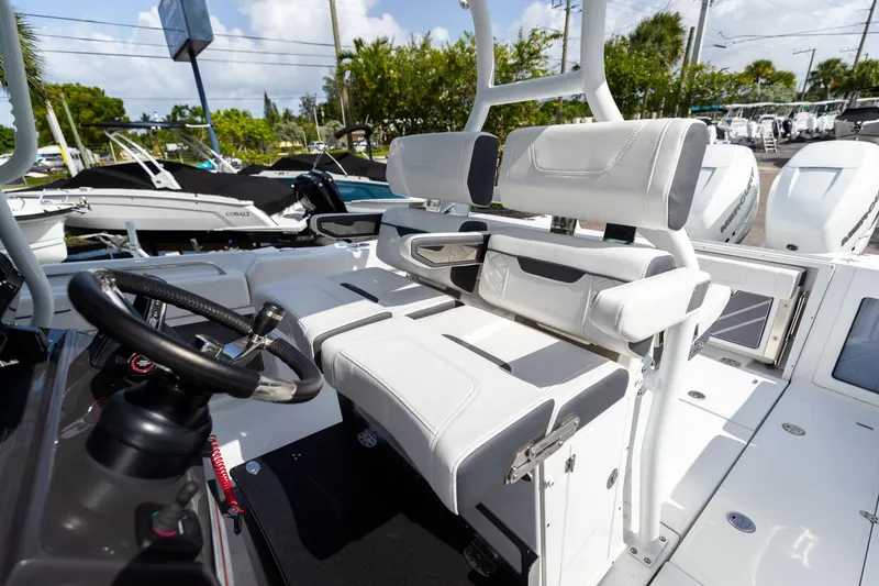 Slide: The Image of 2023 Blackfin 302CC boat interior with white seating and steering wheel. - 39
