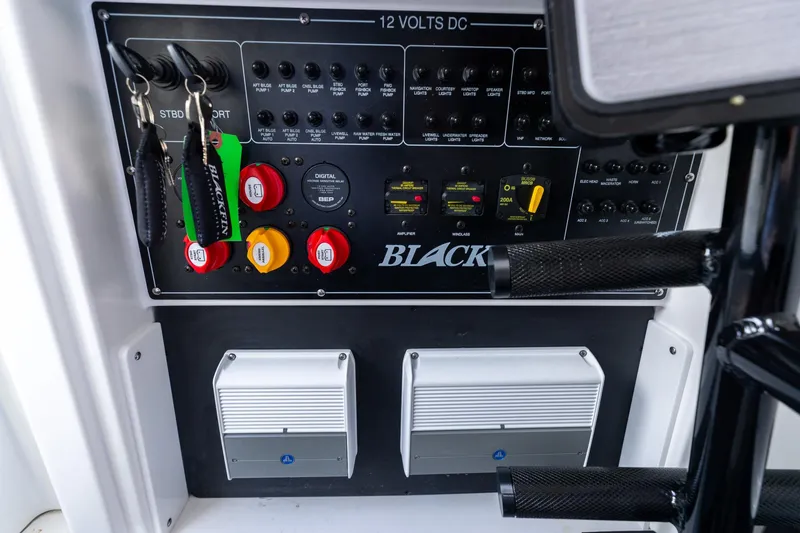 Slide: The Image of Control panel of 2023 Blackfin 302CC boat with switches and key holders. - 44
