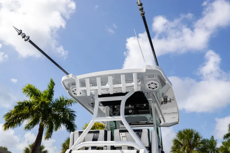 Slide: The Image of 2023 Blackfin 302CC boat with antennas, palm trees, and blue sky background. - 10