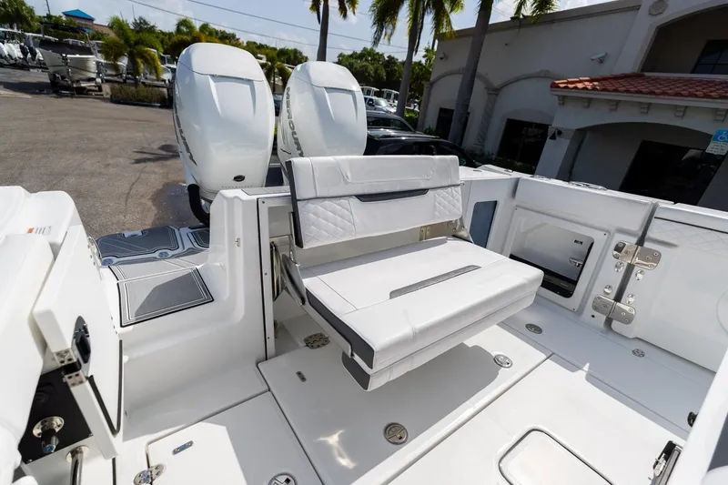 Slide: The Image of 2023 Blackfin 302CC boat interior with seating and dual outboard engines. - 14