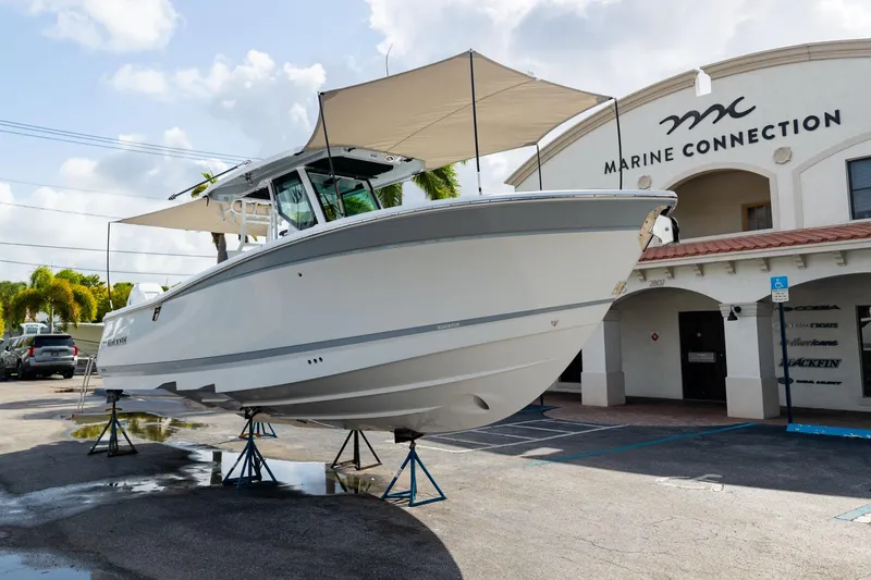 Slide: The Image of 2023 Blackfin 302CC boat displayed at Marine Connection dealership. - 2