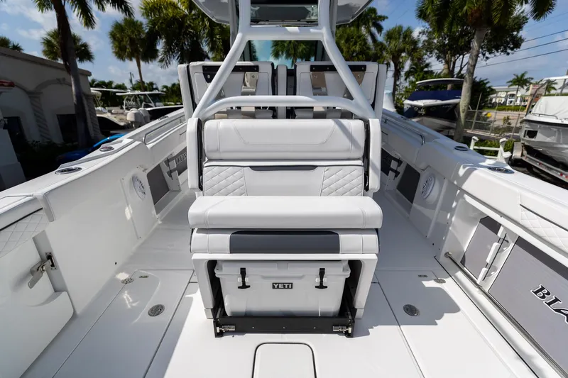 Slide: The Image of 2023 Blackfin 302CC boat interior with seating and Yeti cooler. - 22