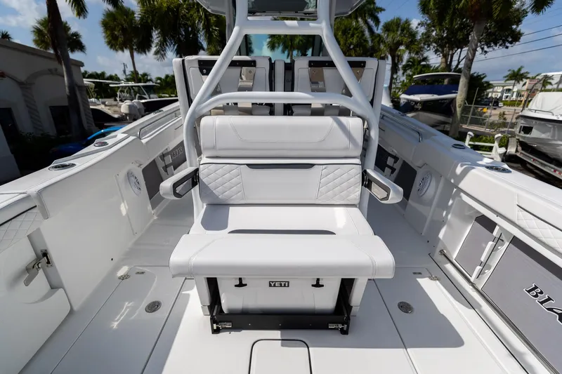 Slide: The Image of 2023 Blackfin 302CC boat interior with white seating and Yeti cooler. - 23