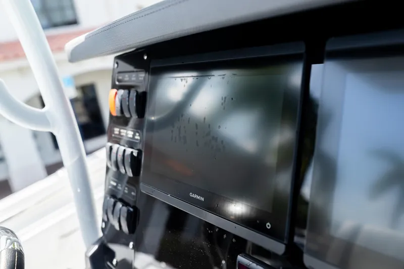 Slide: The Image of Close-up of 2023 Blackfin 302CC boat dashboard with Garmin display and control panel. - 34