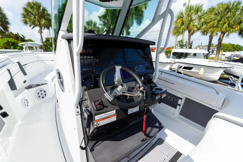 Slide: The Image of 2023 Blackfin 302CC boat cockpit with steering wheel and control panel. - 36