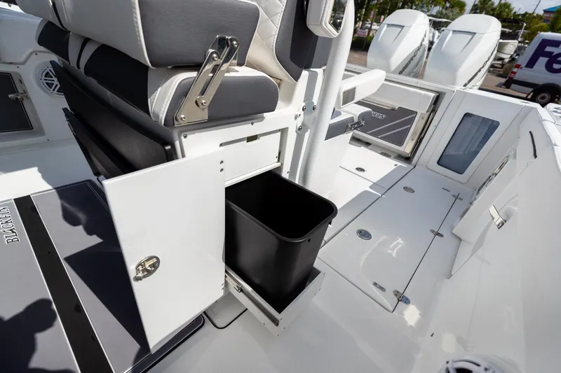 Slide: The Image of 2023 Blackfin 302CC boat interior with storage compartment and seating. - 41
