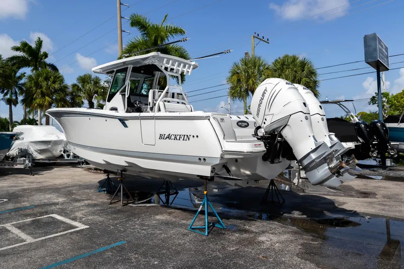 Slide: The Image of 2023 Blackfin 302CC boat with Mercury outboard engines on display in a marina. - 7