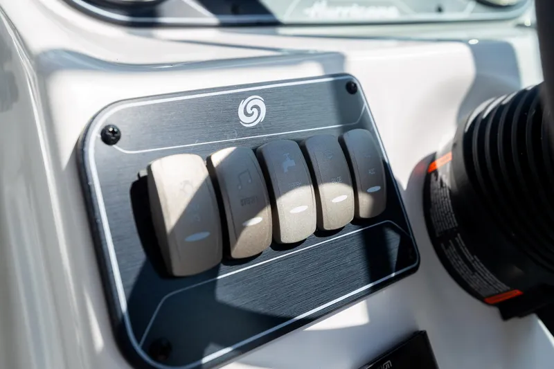 Slide: The Image of Control panel of 2023 Hurricane SunDeck 2200 OB boat with labeled switches. - 20