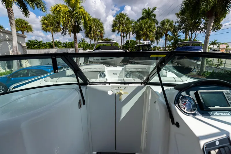 Slide: The Image of 2023 Hurricane SunDeck 2200 OB boat interior with palm trees in the background. - 30