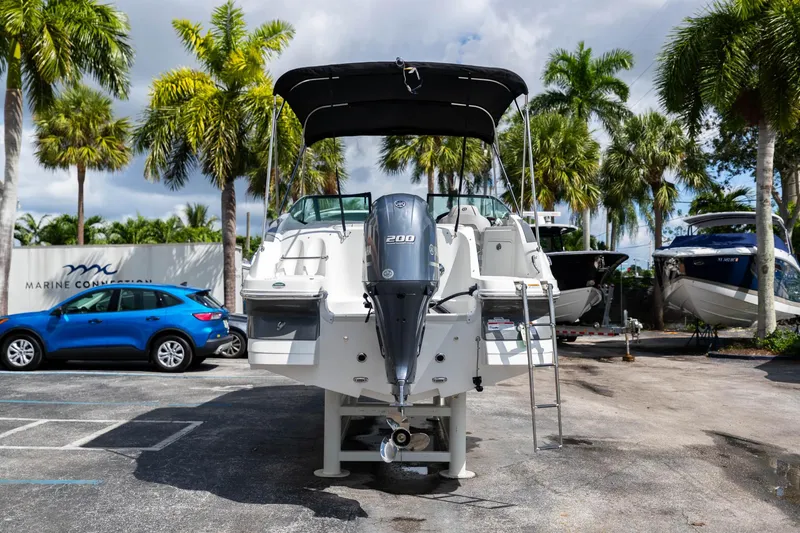 Slide: The Image of 2023 Hurricane SunDeck 2200 OB boat with outboard motor in a tropical setting. - 7