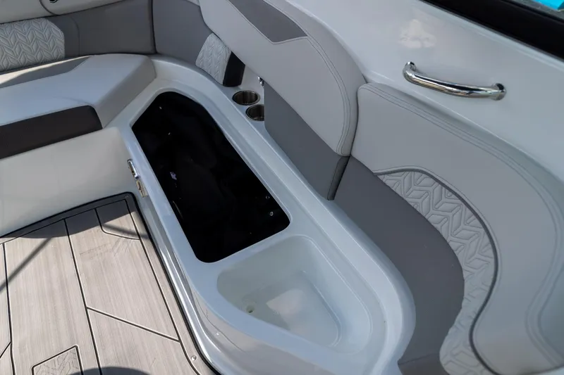 Slide: The Image of 2023 Hurricane SunDeck 2200 OB interior seating with storage compartment and cup holders. - 15