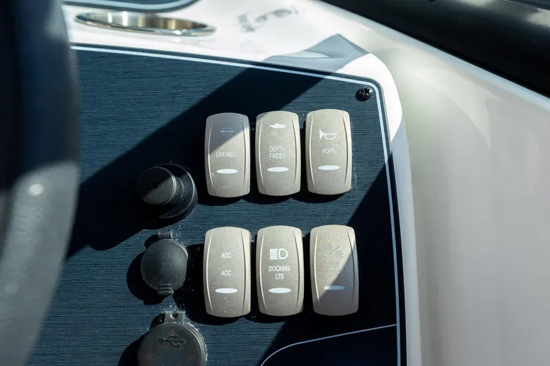 Slide: The Image of Control panel of 2023 Hurricane SunDeck 2200 OB boat with labeled switches. - 22