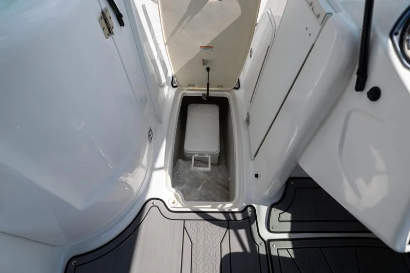 Slide: The Image of 2023 Hurricane SunDeck 2200 OB boat storage compartment with cooler. - 29