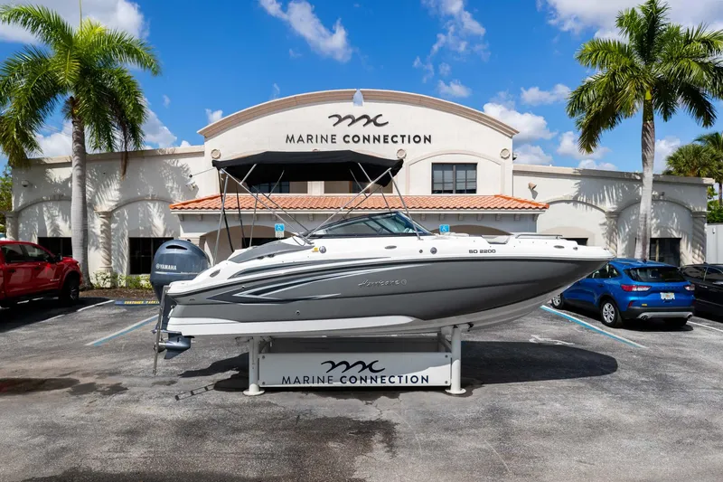 Slide: The Image of 2023 Hurricane SunDeck 2200 OB boat displayed at Marine Connection dealership. - 1