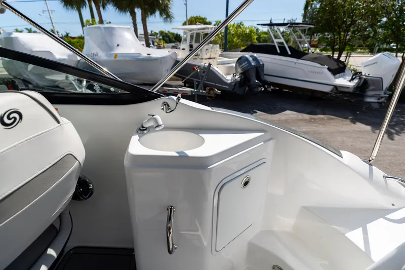 Slide: The Image of 2023 Hurricane SunDeck 2200 OB boat interior with sink and seating area. - 10