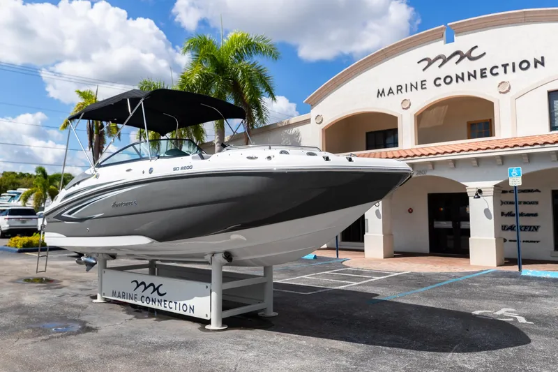 Slide: The Image of 2023 Hurricane SunDeck 2200 OB boat displayed at Marine Connection dealership. - 2