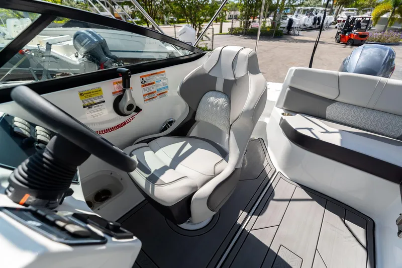 Slide: The Image of 2023 Hurricane SunDeck 2200 OB boat interior with steering wheel and seating. - 24