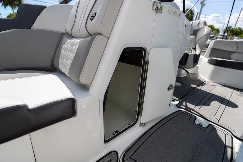 Slide: The Image of 2023 Hurricane SunDeck 2200 OB boat interior storage compartment with open door. - 34