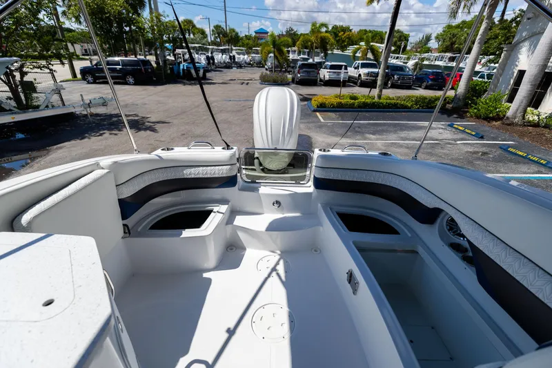 Slide: The Image of 2023 Hurricane SunDeck 2690 OB boat interior, featuring spacious seating and storage compartments. - 13