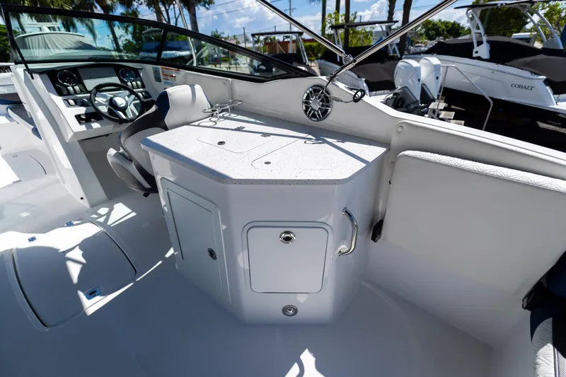 Slide: The Image of 2023 Hurricane SunDeck 2690 OB boat interior with helm and seating area. - 14